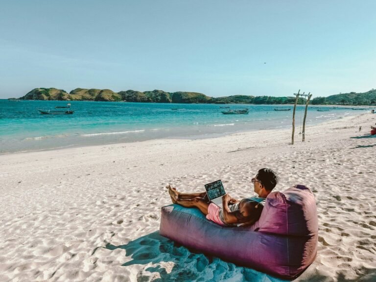 a man sitting on a bean bag on the beach