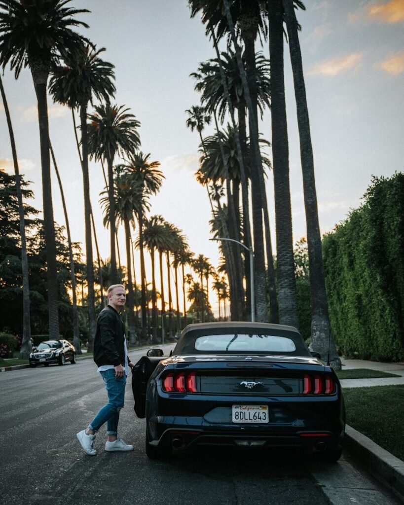 a man walking down the street next to a car