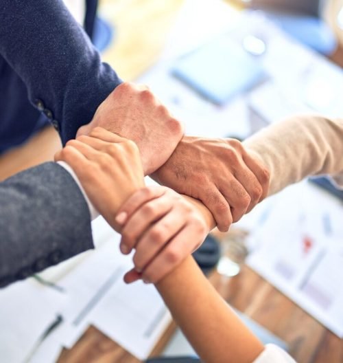 person in black long sleeve shirt holding persons hand